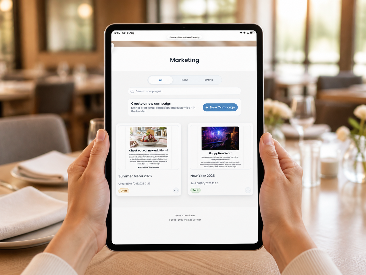 A hospitality manager viewing Client Reservation email campaigns on a portrait iPad