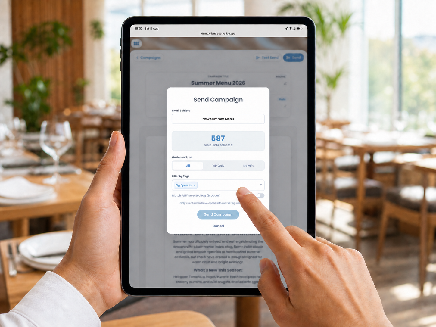 A hospitality professional selecting an audience of 587 marketing recipients on a portrait iPad