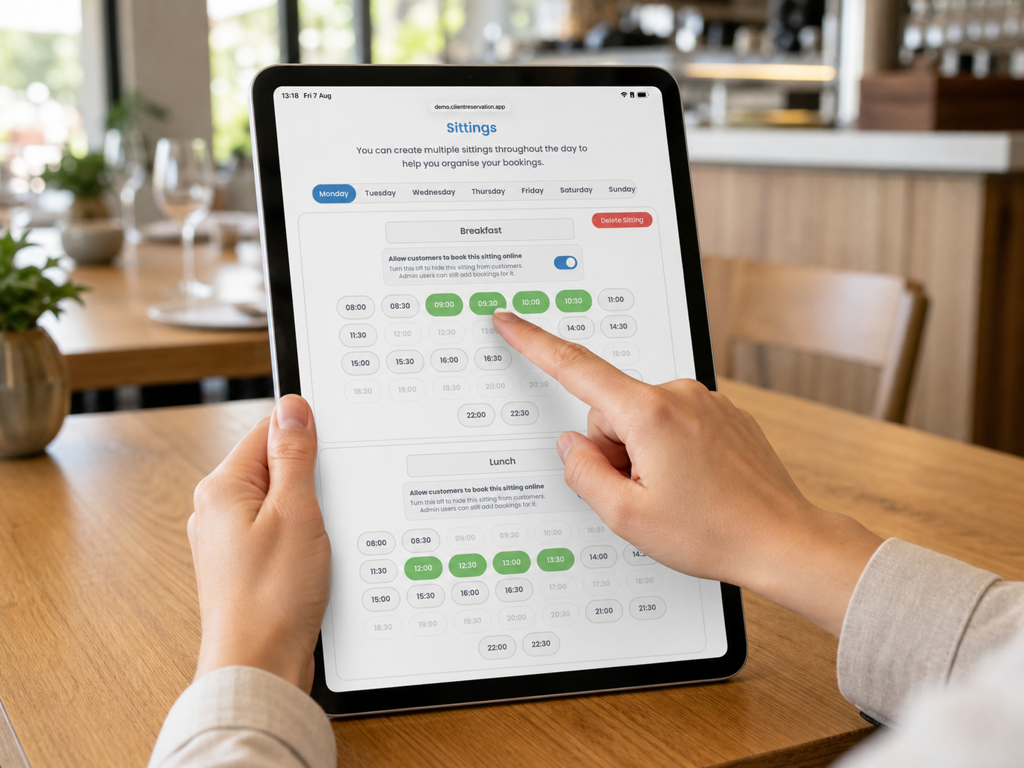 A restaurant manager assigning booking times to sittings on an iPad