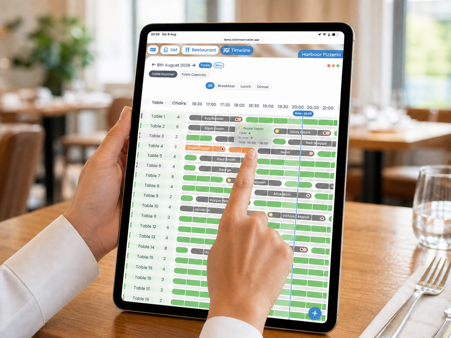 A restaurant staff member pressing the final orange segment of the Grace Taylor booking on a Timeline displayed on a portrait iPad